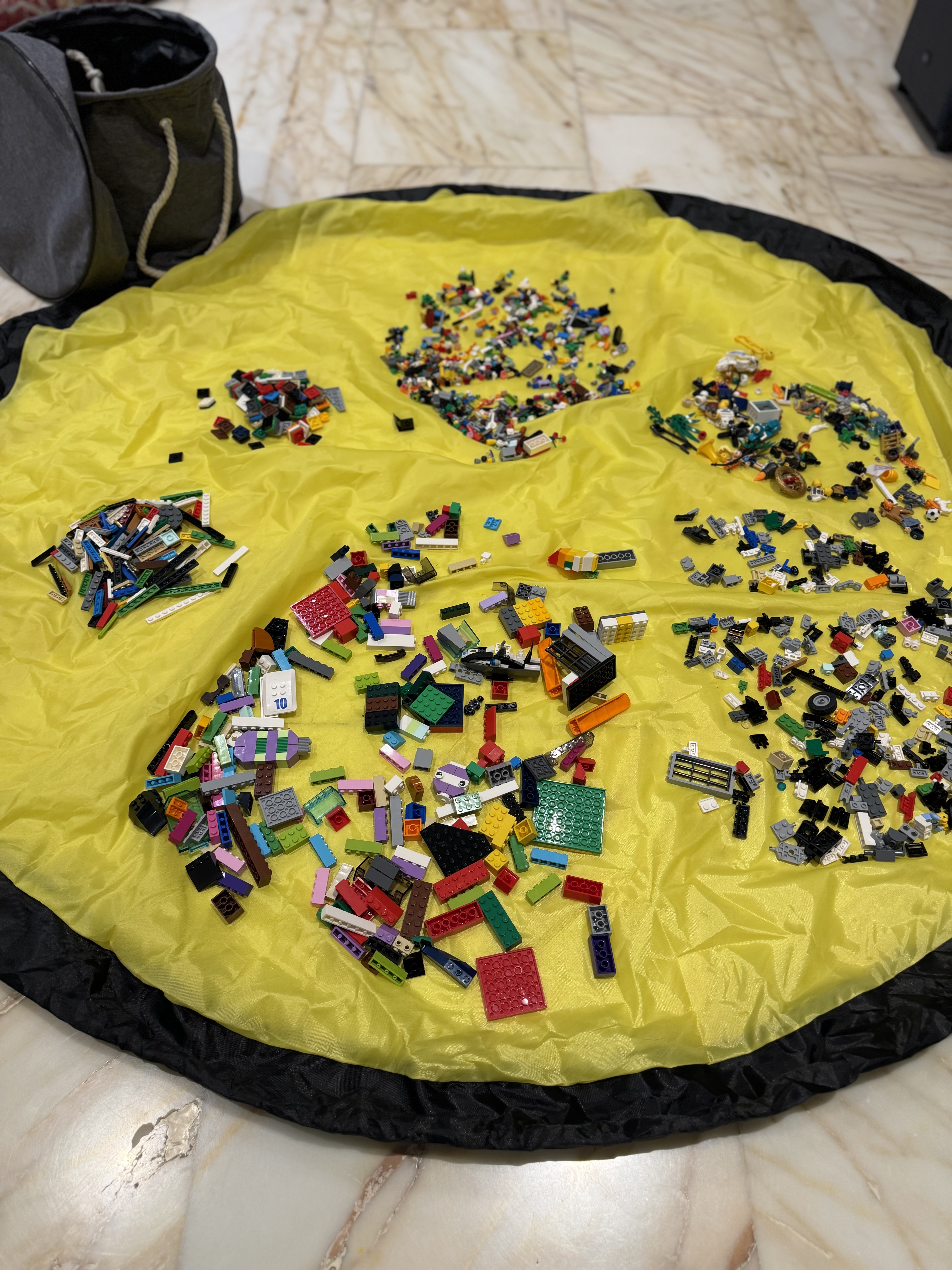 Bricks spread out on the yellow play mat